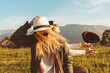 © ADDICTIVE STOCK - Stylish women on meadow in mountains