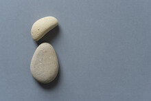 Two Pale Yellow Stones On Gray Background