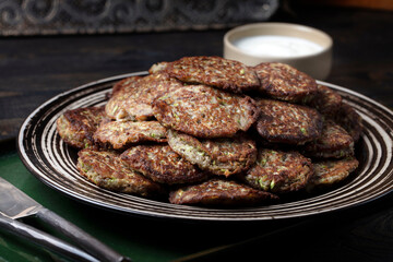 Wall Mural - Homemade vegetarian zucchini and mushrooms pancakes served with unsweetened yogurt