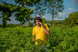 © Dip Photography - Young man farmer in a cotton farm talking or using mobile.