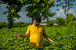 © Dip Photography - A young man farmer in a cotton farm examines and observing the field.