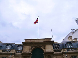 Wall Mural - The flag of the US embassy in Paris mixed with the Pride flag.