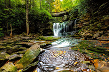 Elakala Waterfall In Blackwater Falls State Park In West Virginia In Fall Autumn Season With Colorful Leaves Foliage Over Bridge And Swirling Pool Stream Unique Nature