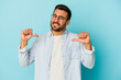 © Asier - Young caucasian man isolated on blue background feels proud and self confident, example to follow.