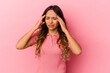 © Asier - Young mexican woman isolated on pink background having a head ache, touching front of the face.
