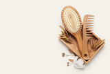 Box with hair brush and comb on color background