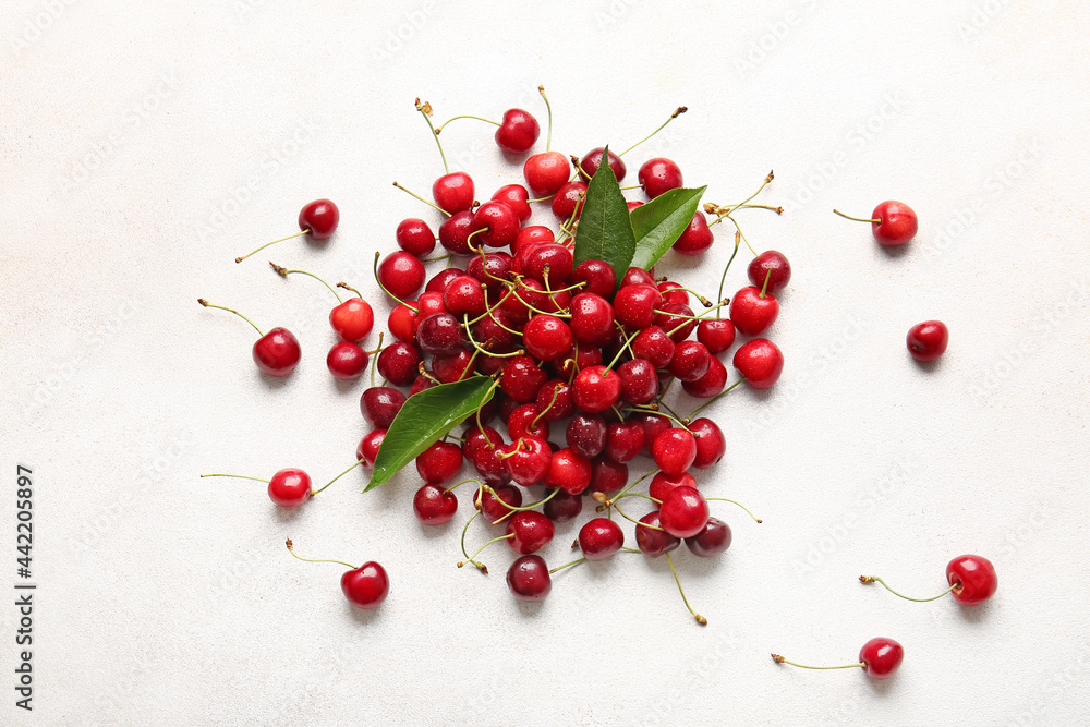 Heap of tasty ripe cherry on light background