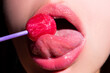 © Volodymyr - Woman licking lollipop, art banner, red lips with lollipop. Sexy red female mouth and tongue with lolli pop. Art print for design.