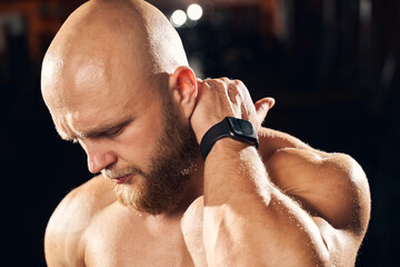 Wall Mural - Handsome sportsman cringing from neck muscle soreness