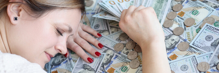 Wall Mural - Woman with money in her hands sleeping on dollar bills