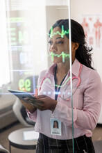 Female Doctor Reviewing Medical Vital Signs In Clinic
