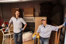 Portrait Confident Movers In Storage Facility Locker