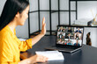© Kateryna - Asian successful young woman talking on video conference with multiracial business team, discussing the project and strategy. Online business meeting, brainstorm of employees, online conversation