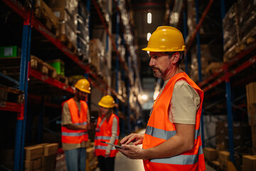 Wall Mural - Handsome man warehouse worker with a tablet.