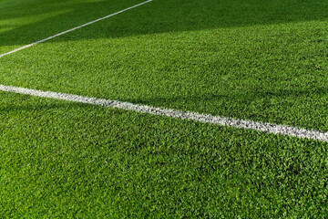 Wall Mural - green artificial grass football or soccer field with white line background