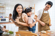 © Kawee - Asian happy family stay home in kitchen bake bakery and dance together