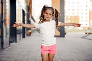 little girl in white t-shirt. space for your logo or design. Mockup for print