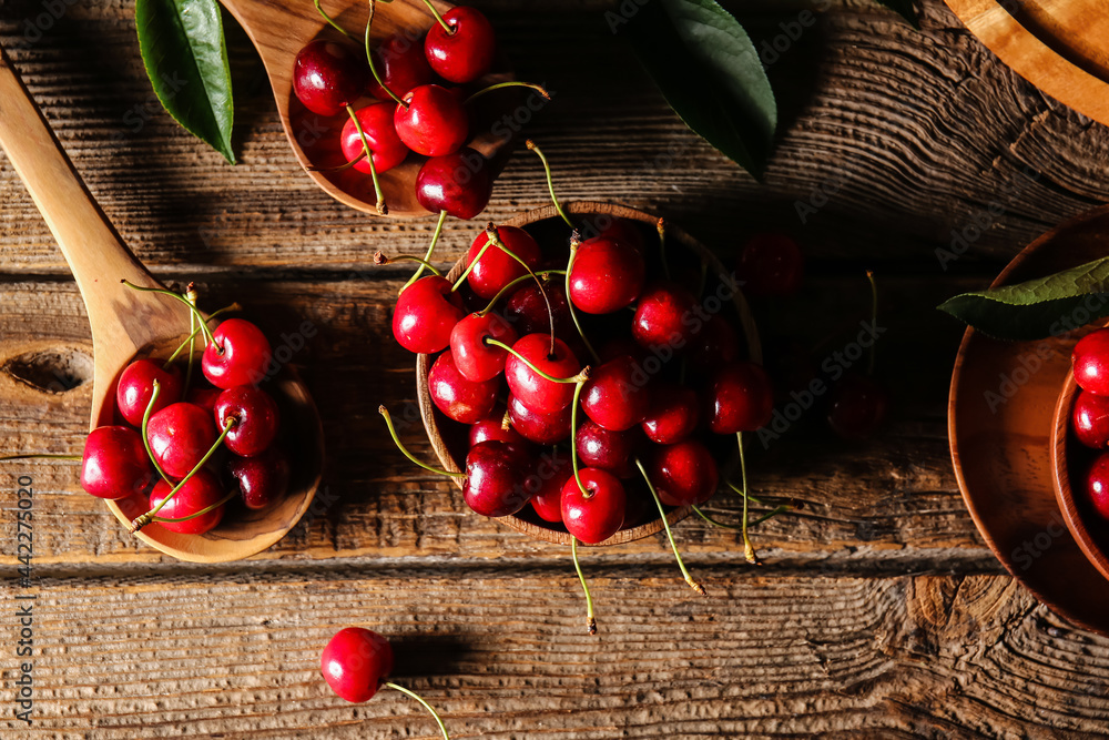 Composition with tasty ripe cherry on wooden background