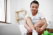 © fotofabrika - Young woman in sportswear using laptop to watch workout video tutorials at home