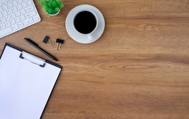 Wall Mural - Top view above of Wooden office desk table with keyboard computer, notebook, paperwork with equipment other office supplies. Business and finance concept. Workplace, Flat lay with blank copy space.