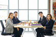 © chadchai - Business executives team meeting in modern office with laptop computer, coffee and document on table. People corporate business team concept.