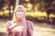 © liderina - Young woman in the park with face mask.