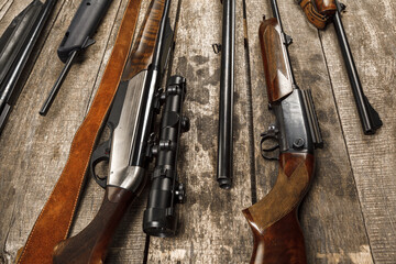 Wall Mural - Many hunting rifles on weathered wooden surface