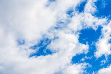 Dramatic blue sky with white clouds background.