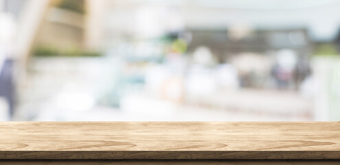 Fototapete - Empty wood table in coffee shop background bokeh light .Mock up for display of product,Banner for advertise on online media,business presentation