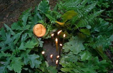 Wall Mural - Burning candles, symbolic moon, oak and fern leaves on natural background. old pagan, Wiccan, Slavic traditions. Witchcraft, esoteric ritual for Summer Solstice Day, Midsummer, Litha sabbath