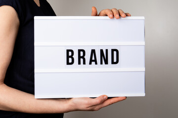 Wall Mural - BRAND. Reliability, evaluation and development concept. Text in light box