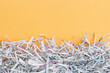 © iama_sing - The shredded paper on light orange background.