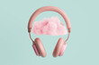 Pink headphones with a pink cloud on turquoise background, 3D rendering