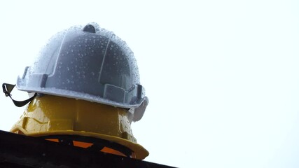 Canvas Print - heavy rain and construction safety helmets, hard safety helmet and raining, construction site