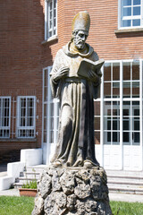 burgos, spain - june 29, 2021: stone statue of st. augustine of hippo doctor of the church with a bo