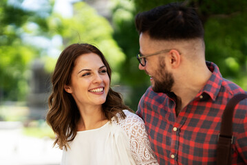 Happy young couple outdoors. Loving couple walking in the city