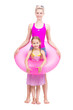 © Mediaphotos - Vertical full length studio portrait of modern Caucasian woman and girl wearing summer clothes standing together in swim ring having fun