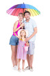 © Mediaphotos - Vertical full length studio portrait of family with one little daughter wearing summer outfits spending time on vacation, white background