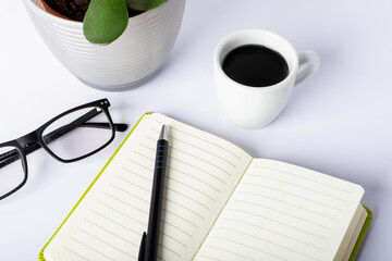 Wall Mural - Office table desk with open blank notebook, glasses and coffee cup. Selective focus.