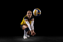 Female Professional Volleyball Player With Ball Isolated On Black Studio Background. The Athlete, Exercise, Action, Sport, Healthy Lifestyle, Training, Fitness Concept.