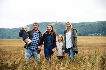 Canvas Print - Happy family walking in a field