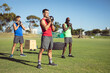 © Wavebreak Media - Diverse group of muscular men exercising with kettle bells outdoors