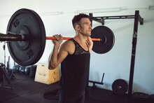 Fit Caucasian Man Exercising At Gym, Lifting Weights On Barbell