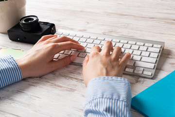 Freelancer sitting at desk and typing on keyboard