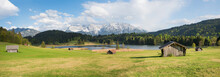 Alpine Meadow With Wooden Huts, View To Karwendel Mountains, Panorama Bavaria