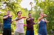 © Rido - Multiethnic mature people exercising in park with dumbbells at park
