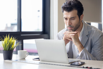 Wall Mural - Businessman in shirt working on his laptop in an office. Open space office