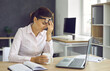 © Studio Romantic - Young tired woman resting during a break from office work, raising her glasses, resting her hand on her face and closing her eyes. Beautiful woman holding a white mug during work break.