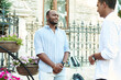 © etonastenka - A black businessman is talking in an informal setting with a business partner on a city street