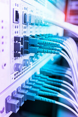 Fiber Optical cables connected to an optic ports and Network cables connected to ethernet ports